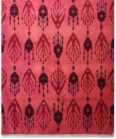 Handmade Afghan wool runner featuring a repeating ikat-style pattern in shades of red and purple.