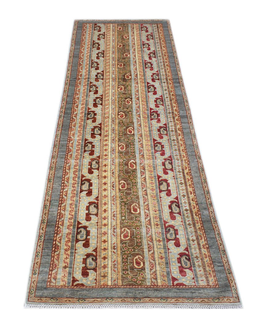 A handmade Afghan Chobi runner rug featuring traditional geometric patterns in earthy tones.