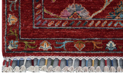 A handmade Afghan Chobi runner featuring a red field with floral motifs and a tasseled fringe.