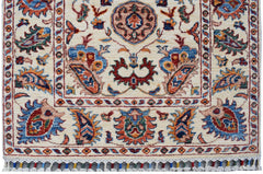 Handmade Afghan Chobi runner rug featuring traditional floral patterns in a cream color palette.