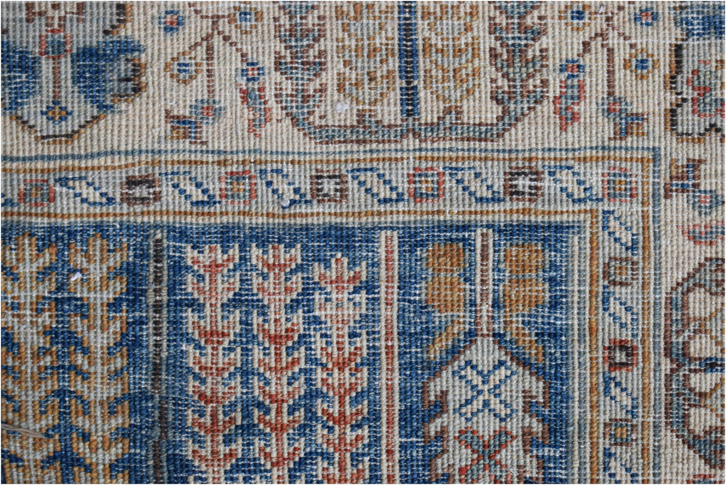 A close-up of a handwoven Afghan Chobi runner featuring intricate geometric and floral patterns.
