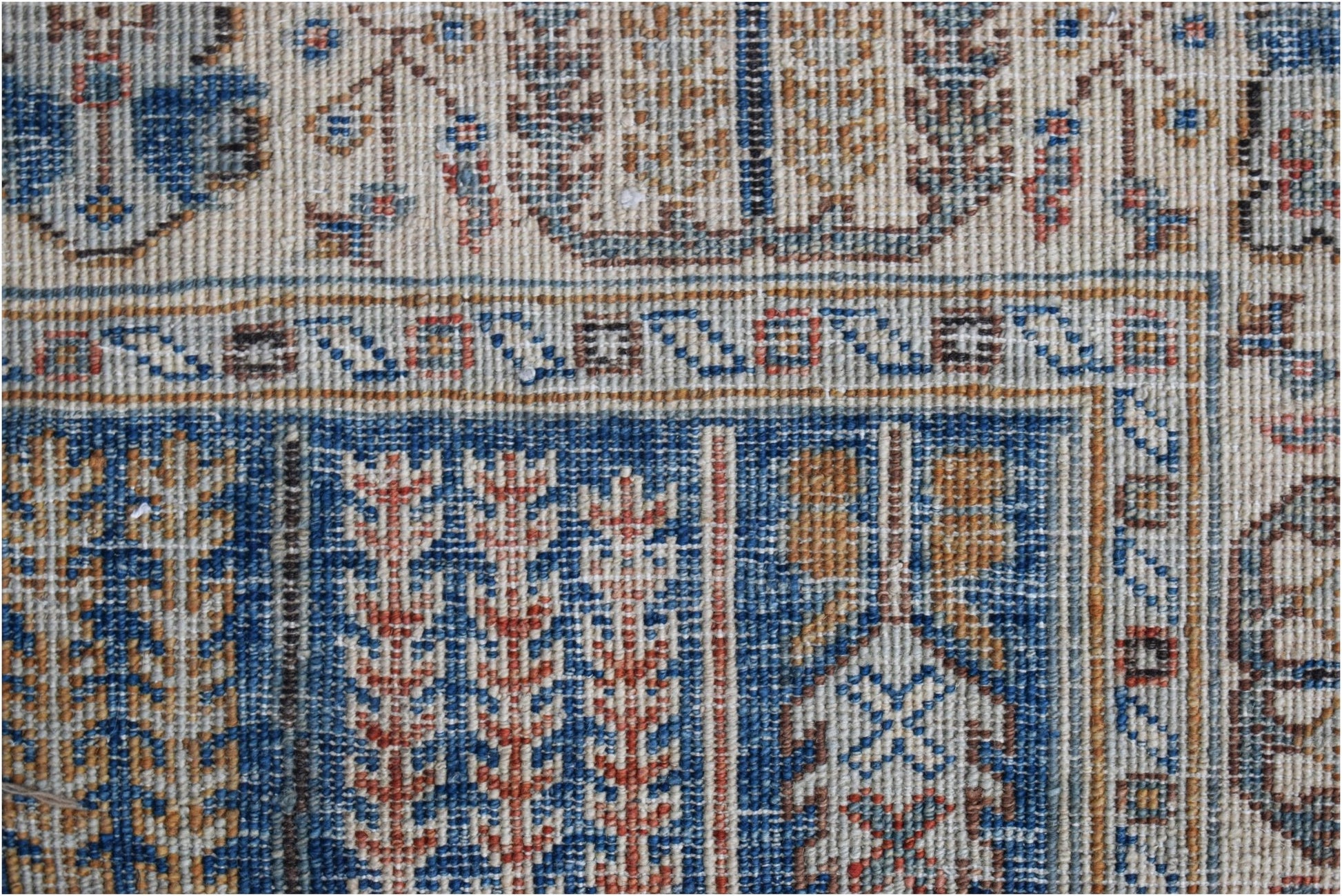 A close-up of a handwoven Afghan Chobi runner featuring intricate geometric and floral patterns.