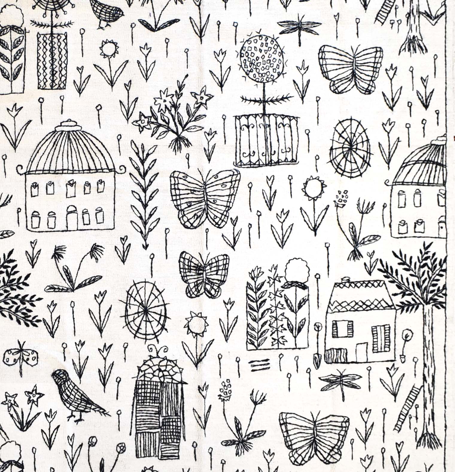 A white wool kilim featuring a black hand-embroidered pattern of houses, butterflies, and flowers.