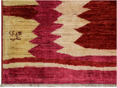 Handmade Afghan Gabbeh rug featuring a geometric pattern in shades of red, pink, and beige.