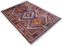 A rectangular Afghan Herati rug featuring geometric diamond patterns in red, blue, and yellow.