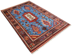 A rectangular Afghan Herati rug featuring a blue field with intricate red and orange tribal motifs.