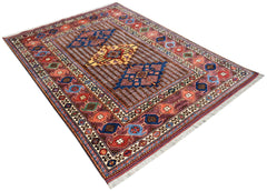 Handwoven Afghan Herati rug featuring a traditional geometric pattern in red, blue, and gold tones.