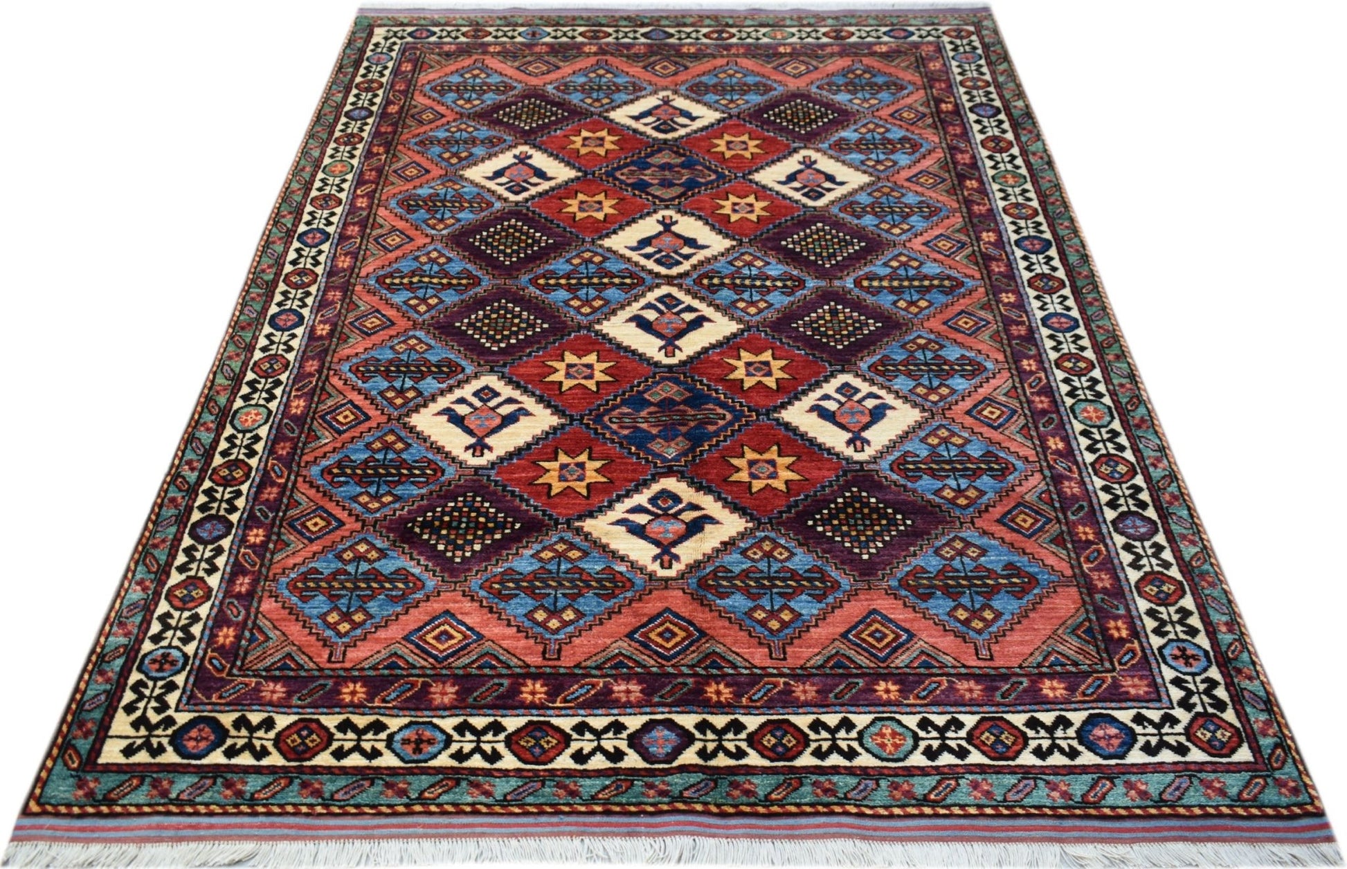 A handwoven Afghan Herati rug featuring a geometric diamond pattern in red, blue, and cream tones.