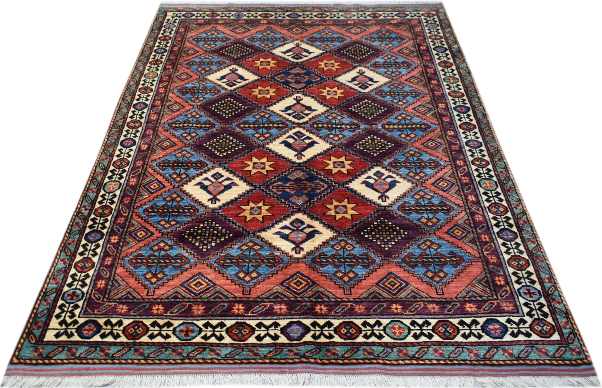 A handwoven Afghan Herati rug featuring a geometric diamond pattern in red, blue, and cream tones.