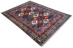An Afghan Herati rug featuring a geometric diamond pattern in red, blue, and cream wool.