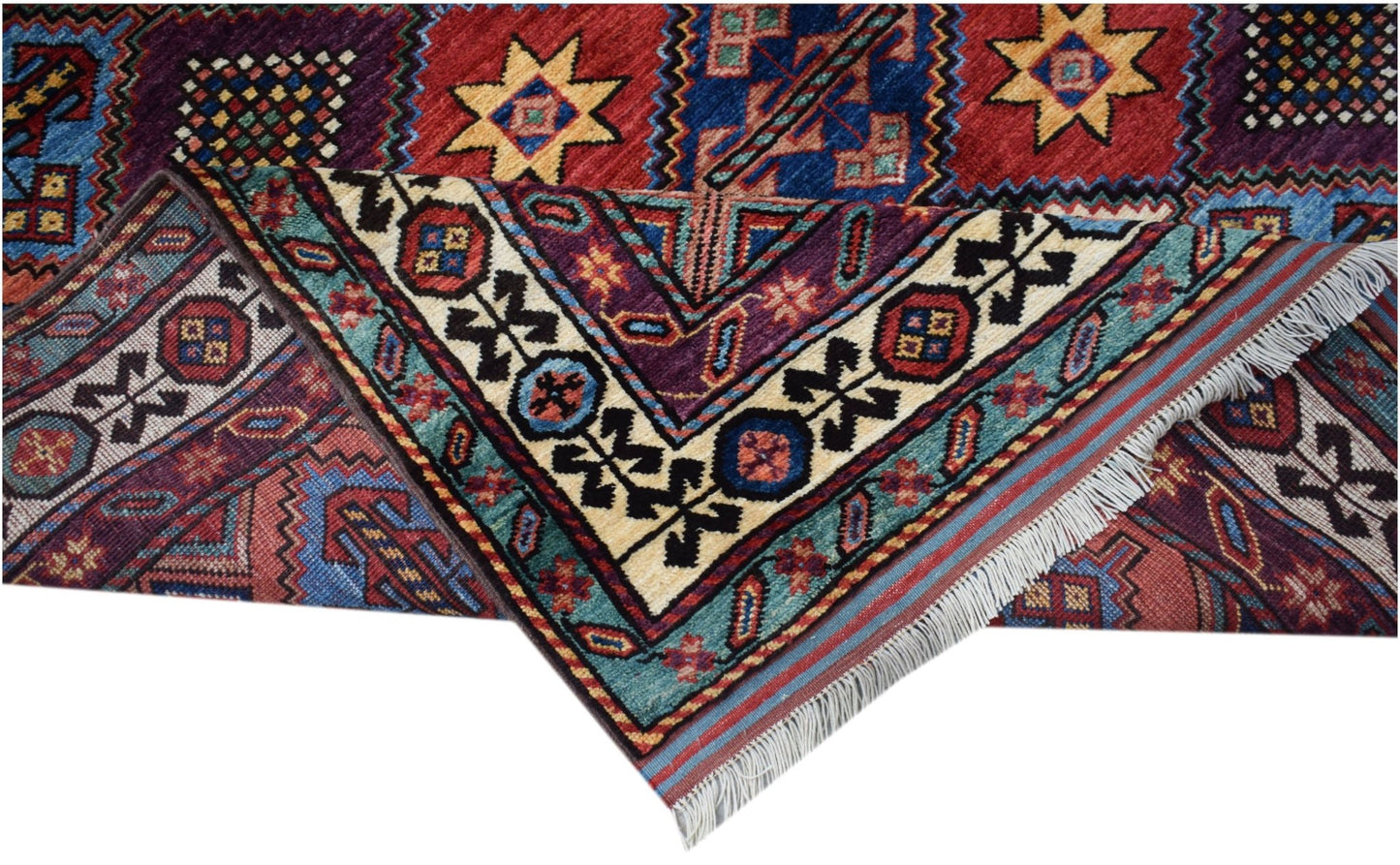 A handwoven Afghan Herati rug featuring intricate geometric patterns in red, blue, and cream tones.