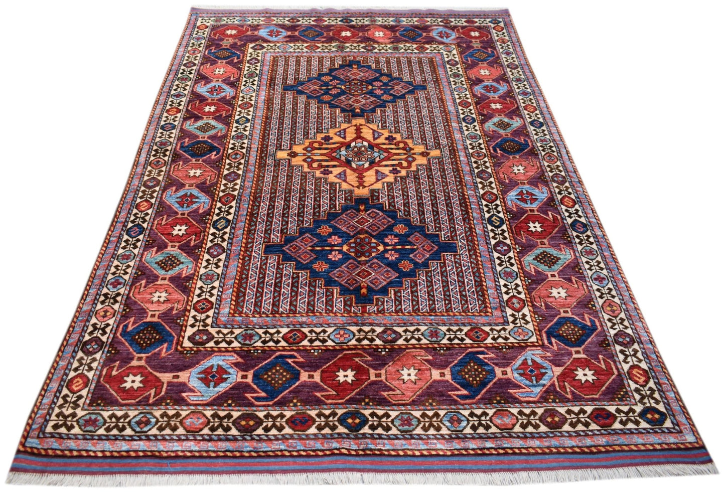 Handwoven Afghan Herati rug featuring a geometric pattern in shades of red, blue, and gold.