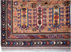 Handwoven Afghan Herati rug featuring traditional geometric patterns in warm earth tones.