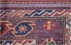 A close-up of a handwoven Afghan Herati rug featuring intricate geometric patterns in wool.