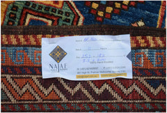A close-up view of a hand-knotted Afghan Herati rug featuring intricate geometric patterns.