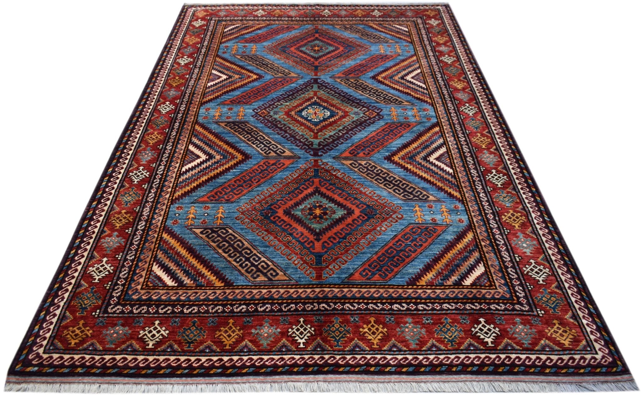 A rectangular Afghan Herati rug featuring a blue field with geometric diamond patterns and red borders.