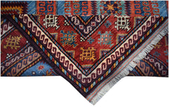 A handwoven Afghan Herati rug featuring a geometric pattern in red, blue, and cream wool.