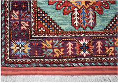 A handwoven Afghan runner featuring a vibrant geometric pattern in blue, red, and purple wool.