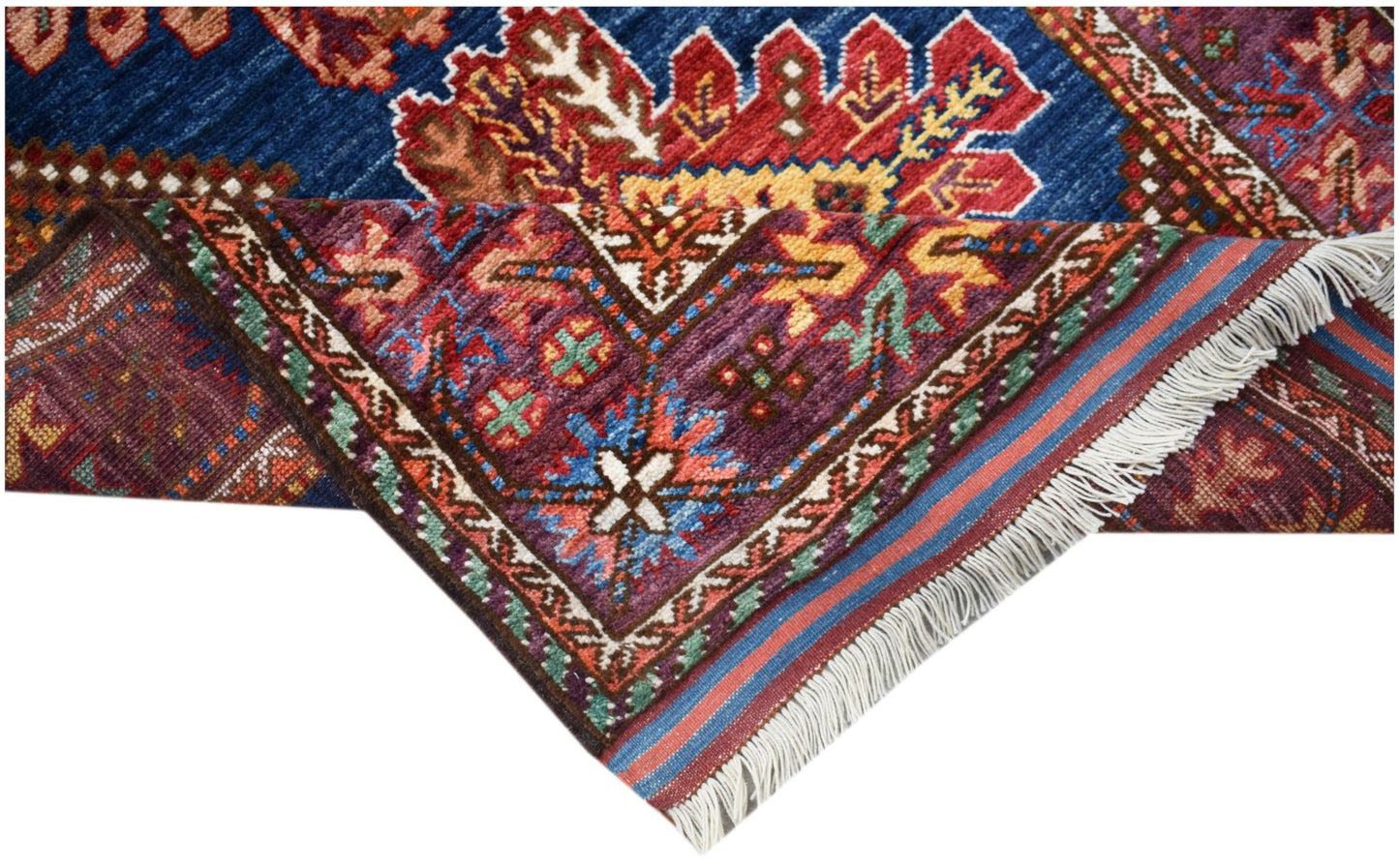 A handwoven Afghan Herati runner featuring intricate floral patterns in blue, red, and purple wool.