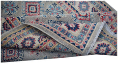A handmade Afghan Kazakh rug featuring traditional geometric motifs in blue, red, and cream tones.