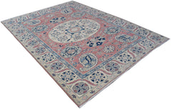 A handmade Afghan Kazakh rug featuring traditional blue and cream floral motifs on a pink field.
