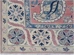 Handmade Afghan Kazakh rug featuring traditional floral motifs in blue, pink, and cream tones.