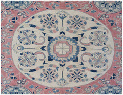 Handmade Afghan Kazakh rug featuring a central floral medallion in pink, blue, and cream tones.