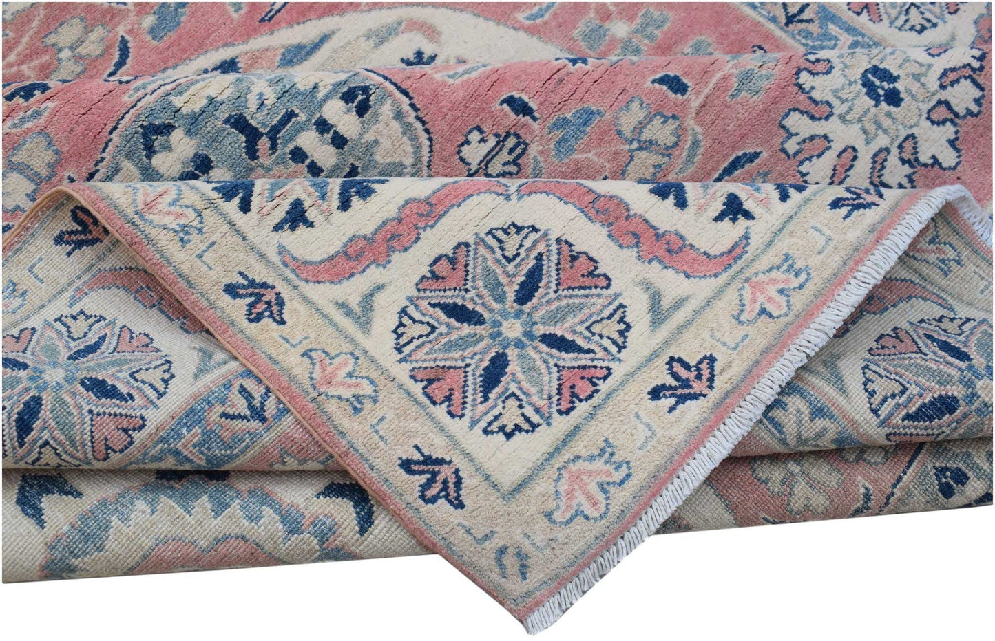 A folded Afghan Kazakh rug featuring traditional floral motifs in shades of pink, blue, and cream.