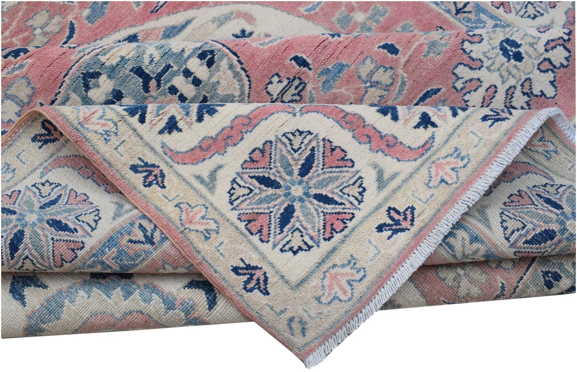A folded Afghan Kazakh rug featuring traditional floral motifs in shades of pink, blue, and cream.