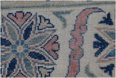 A close-up of an Afghan Kazakh rug featuring traditional geometric floral patterns in wool.