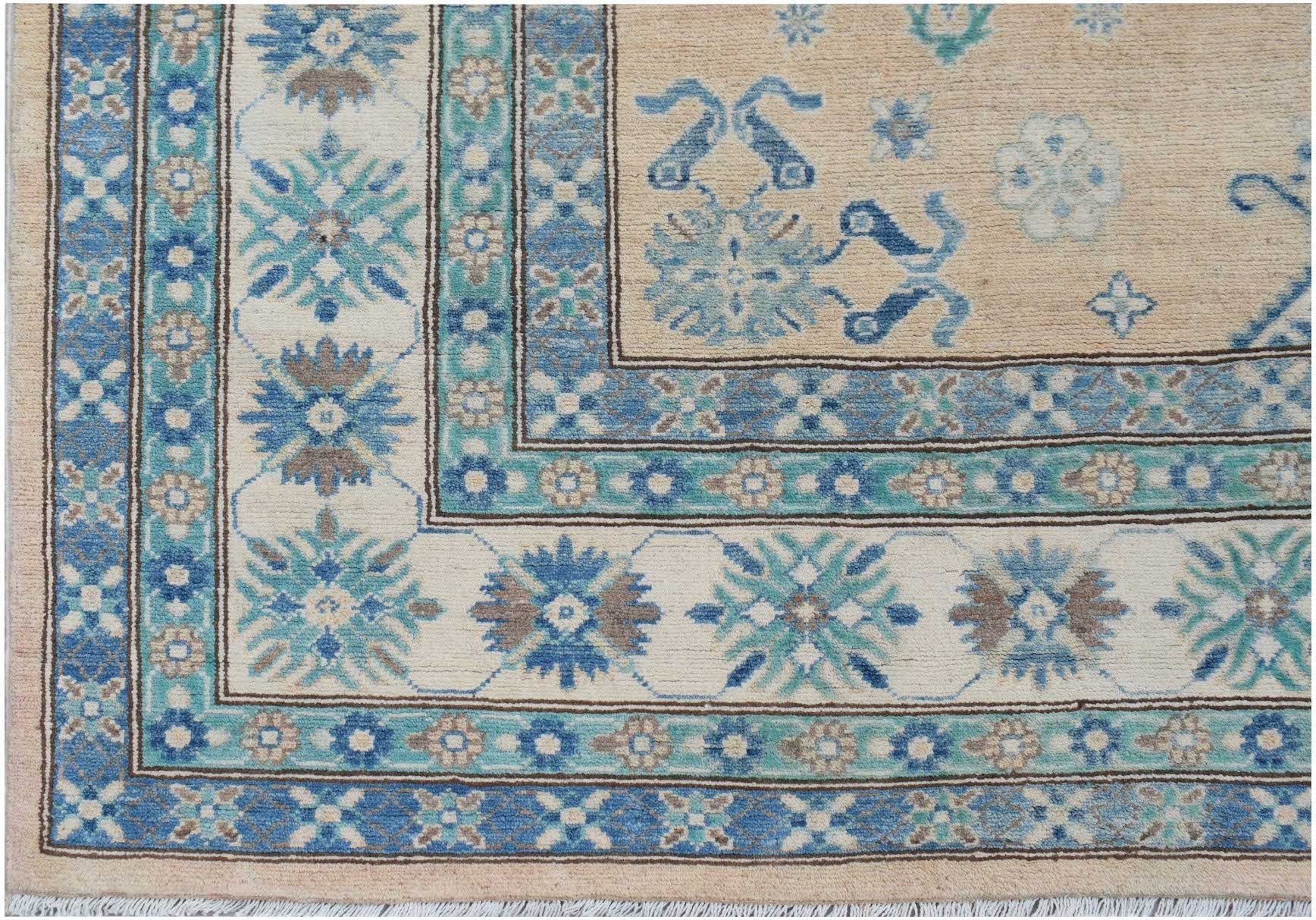 A handmade Afghan Kazakh rug featuring a beige field with blue and grey floral geometric patterns.