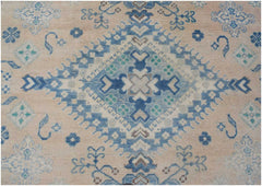 Handmade Afghan Kazakh rug featuring a central blue diamond motif on a beige wool background.