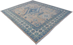 A handmade Afghan Kazakh rug featuring a beige field with blue and grey geometric patterns.