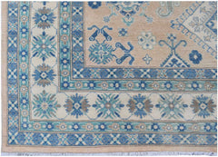 Handmade Afghan Kazakh rug featuring a beige field with blue and grey geometric floral patterns.