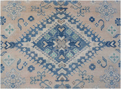 Handmade Afghan Kazakh rug featuring a central blue diamond medallion on a beige wool background.
