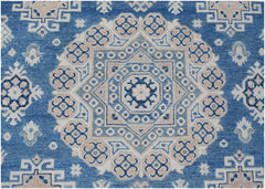 Handmade Afghan Kazakh rug featuring a central geometric medallion in blue, beige, and grey.