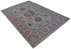 An Afghan Kazakh rug featuring traditional geometric motifs in blue, pink, and cream wool.