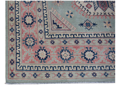 Handmade Afghan Kazakh rug featuring traditional geometric motifs in blue, pink, and cream.