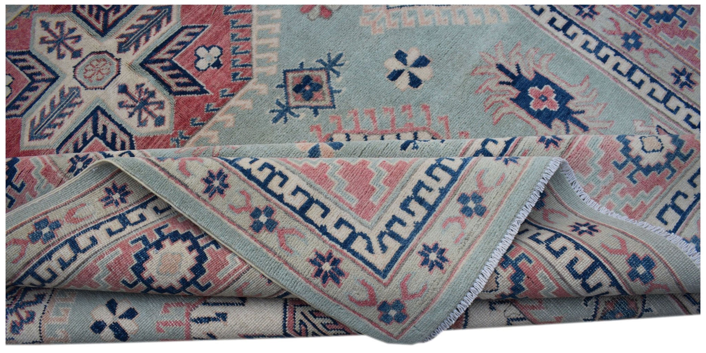 A handmade Afghan Kazakh rug featuring traditional geometric motifs in blue, pink, and cream.