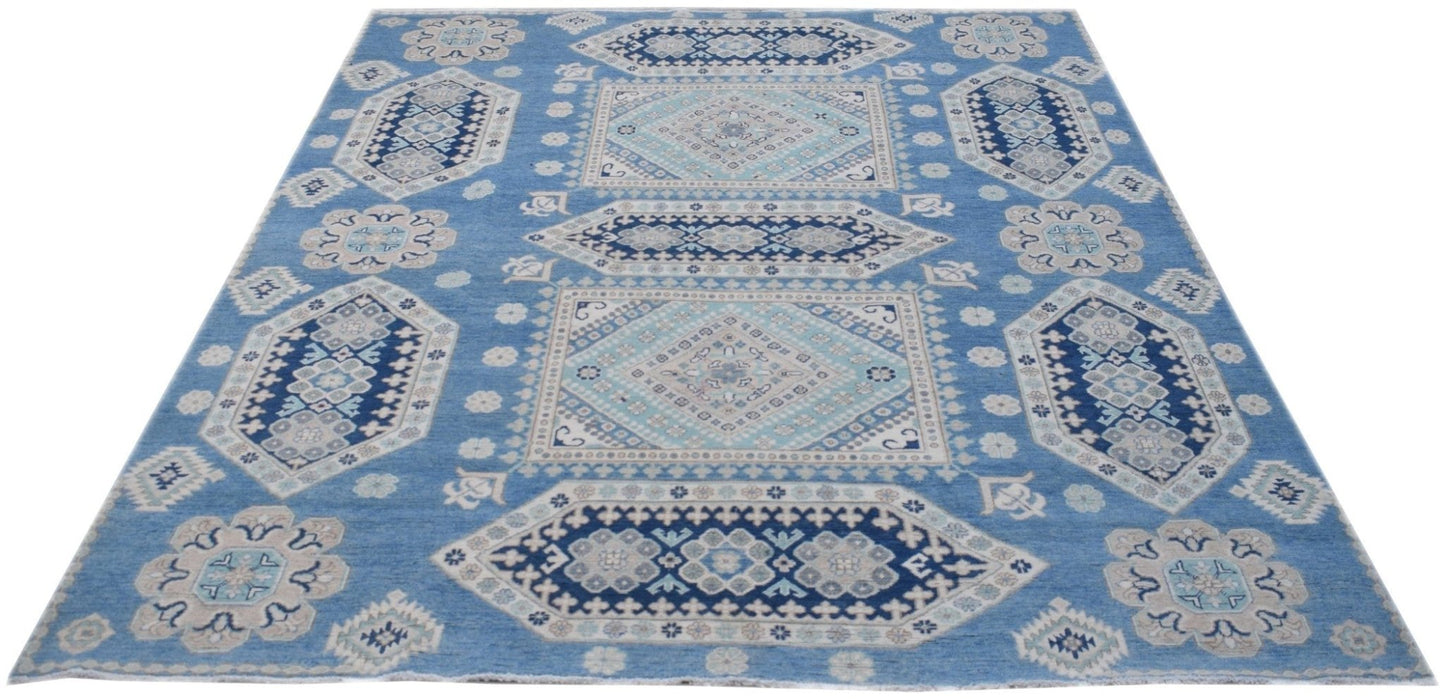Handmade Afghan Kazakh rug featuring a geometric pattern in shades of blue, beige, and grey.