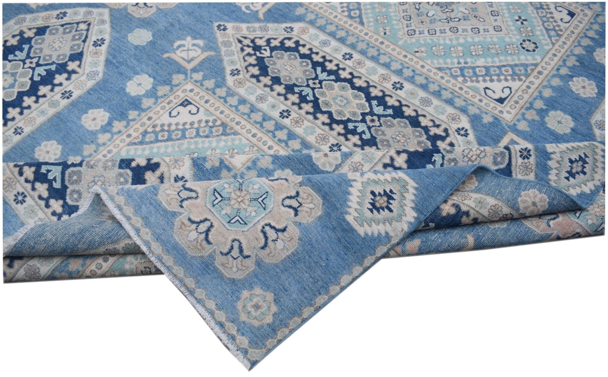 A handmade Afghan Kazakh rug featuring a geometric pattern in shades of blue, beige, and grey.