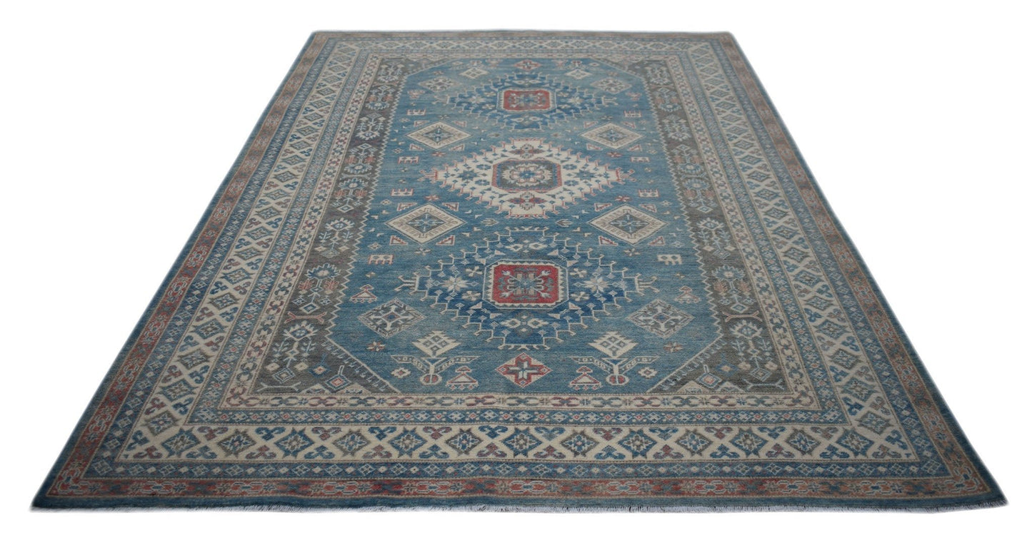 A handmade Afghan Kazakh rug featuring traditional geometric motifs in blue, red, and cream tones.