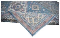 A handmade Afghan Kazakh rug featuring traditional geometric motifs in blue, cream, and red.