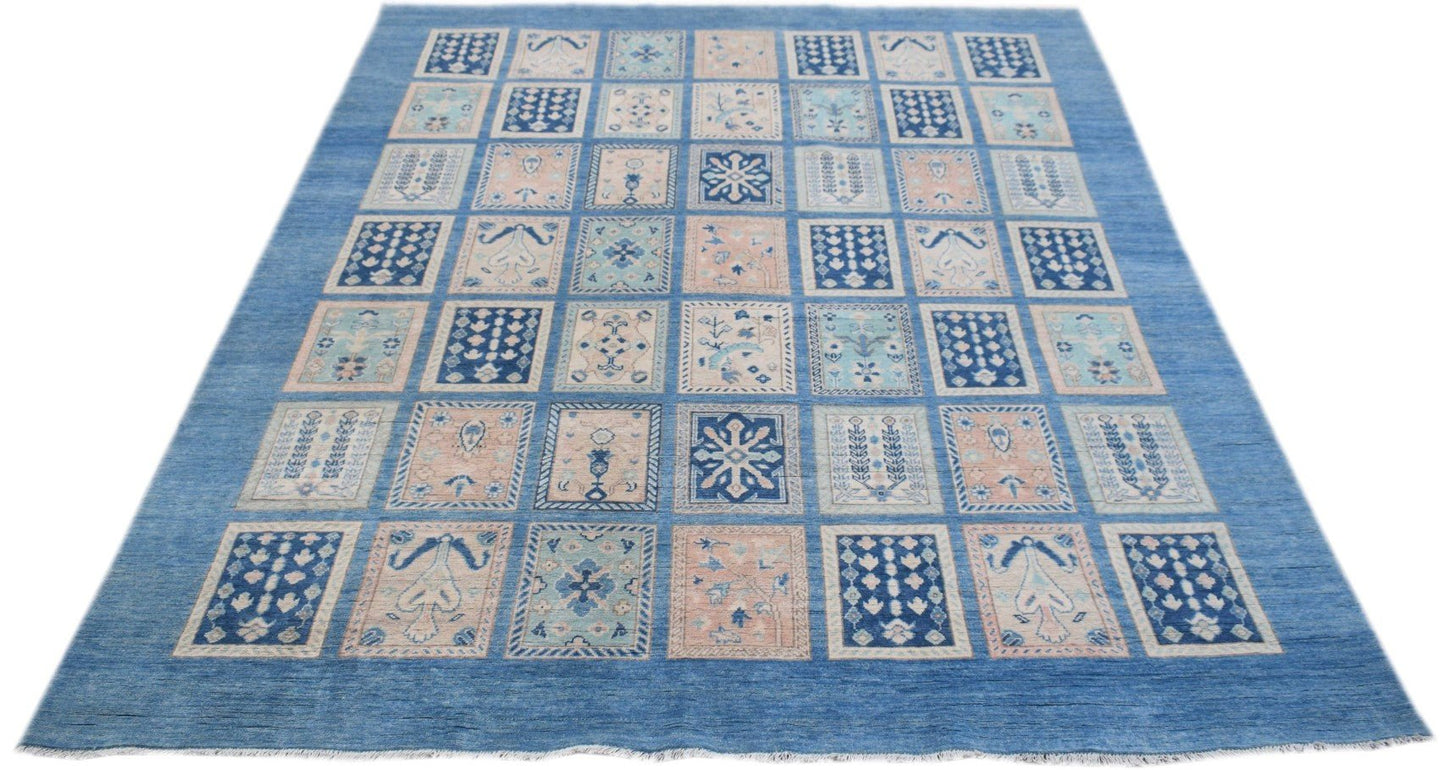 Handmade Afghan Kazakh rug featuring a grid of blue and beige geometric and floral motifs.