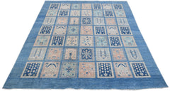 Handmade Afghan Kazakh rug featuring a grid of blue and beige geometric and floral motifs.