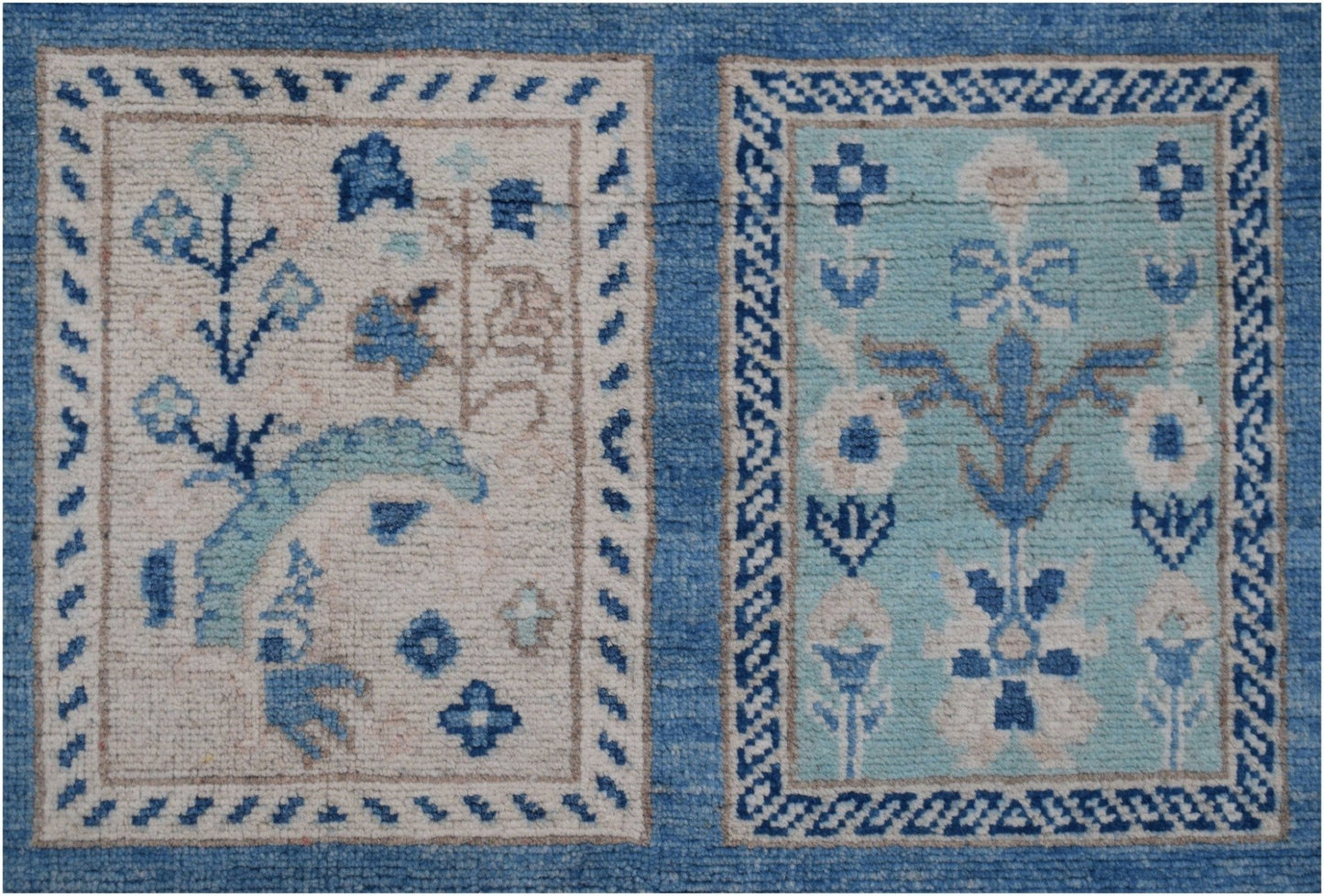 Handmade Afghan Kazakh rug featuring two rectangular panels with blue and beige floral motifs.