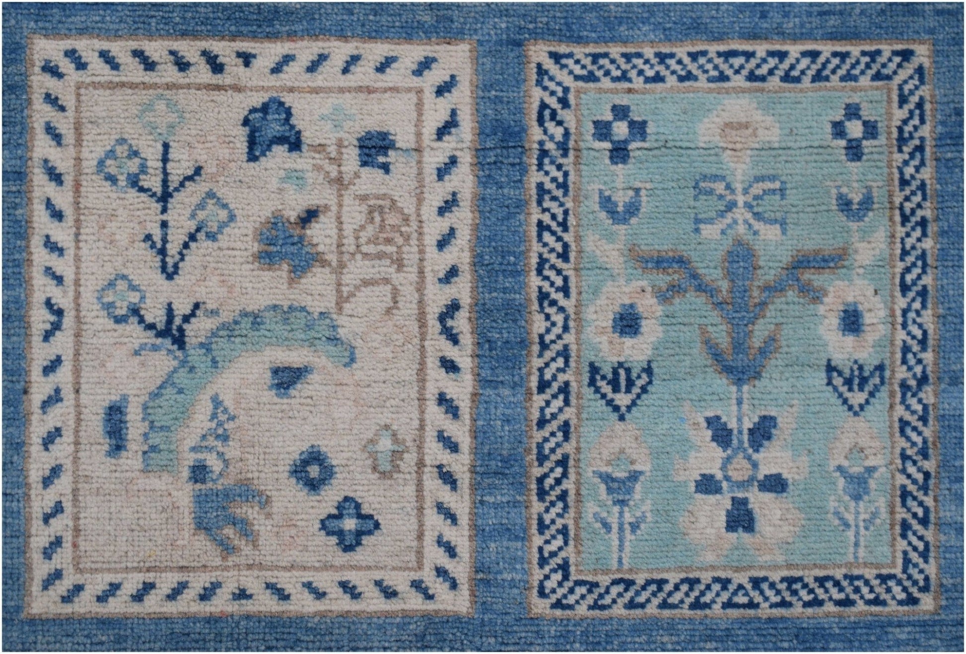 Handmade Afghan Kazakh rug featuring two rectangular panels with blue and beige floral motifs.
