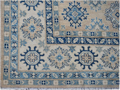 Handmade Afghan Kazakh wool rug featuring traditional blue and beige geometric floral patterns.