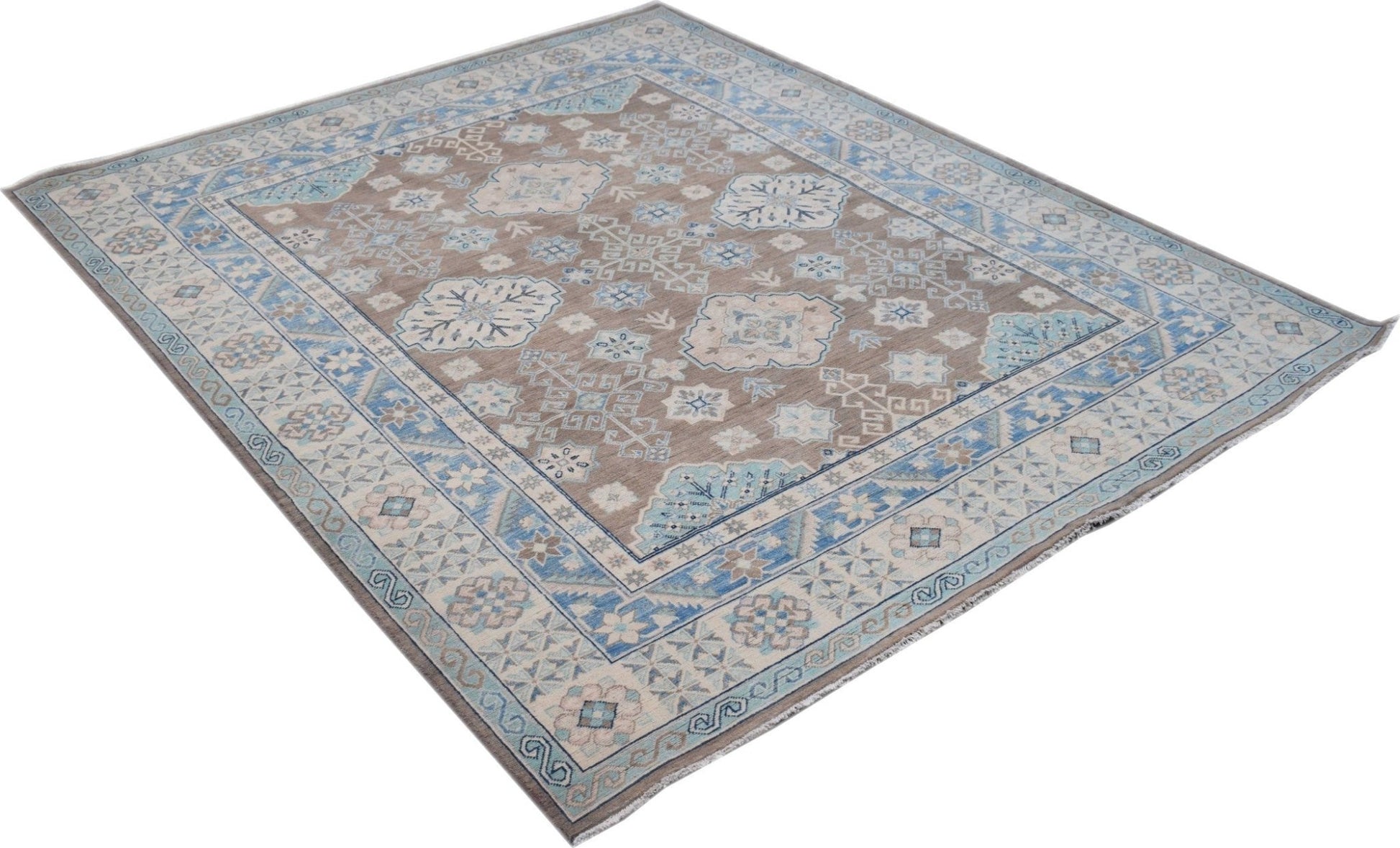 A handmade Afghan Kazakh rug featuring a geometric pattern in shades of beige, blue, and grey.