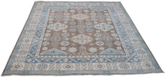 Handmade Afghan Kazakh rug featuring a geometric pattern in shades of brown, blue, and beige.